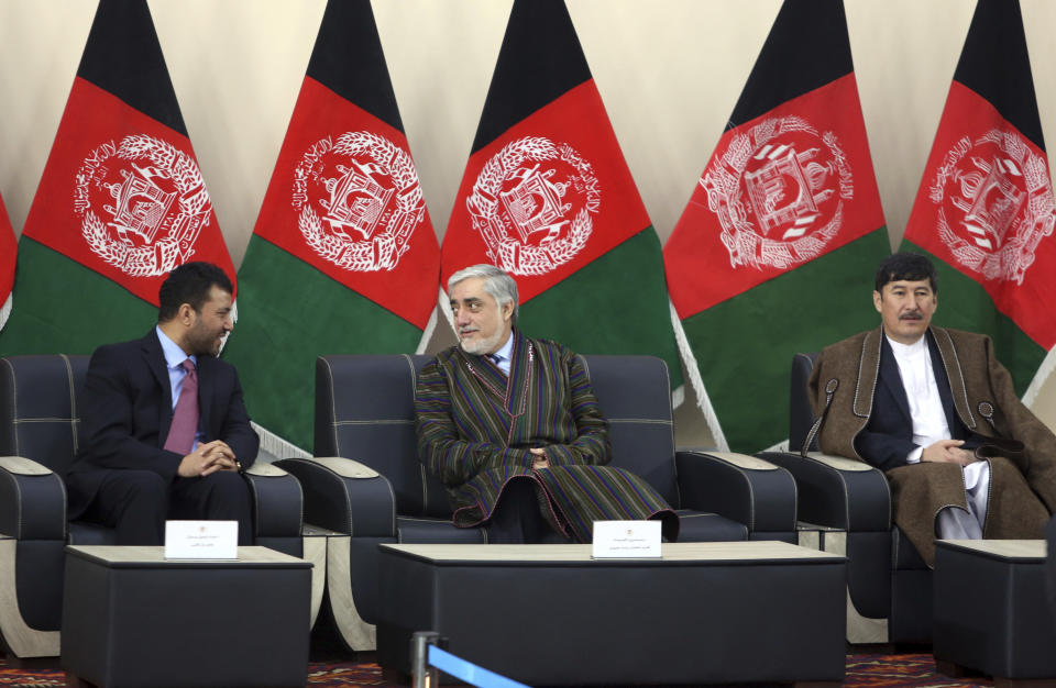 Afghanistan Chief Executive Abdullah Abdullah, center, announces his presidential candidacy along with Enayatullah Babur Farahmand, left, running for first vice president and Asadullah Sahadati, for second vice president, during a ceremony in Kabul, Afghanistan, Sunday, Jan. 20, 2019. Ghani and Chief Executive Abdullah Abdullah on Sunday registered to run for president later this year, setting up a rematch after a bitterly disputed 2014 vote led to a power-sharing agreement brokered by the United States. (AP Photo/Rahmat Gul)
