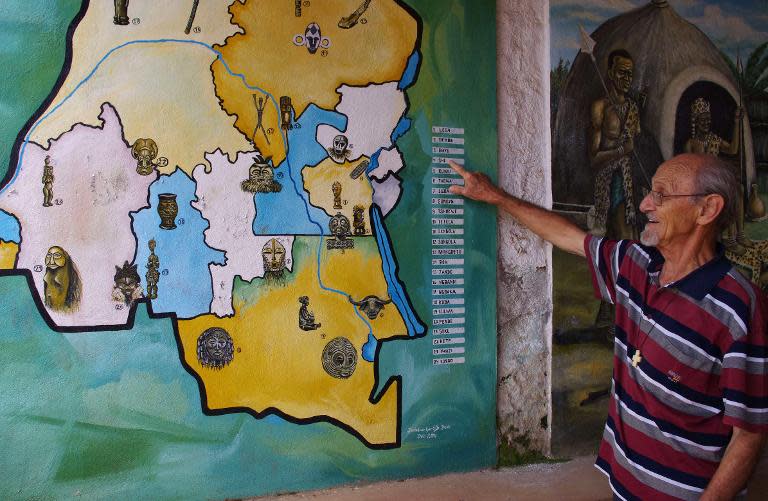 Father Italo, an Italian Catholic missionary living in the DRCongo for almost 40 years, points on a map how to find the Shi tribe, the main ethnic group in the Bukavu region, at the entrance of the Kivu Museum in Bukavu on March 17, 2015