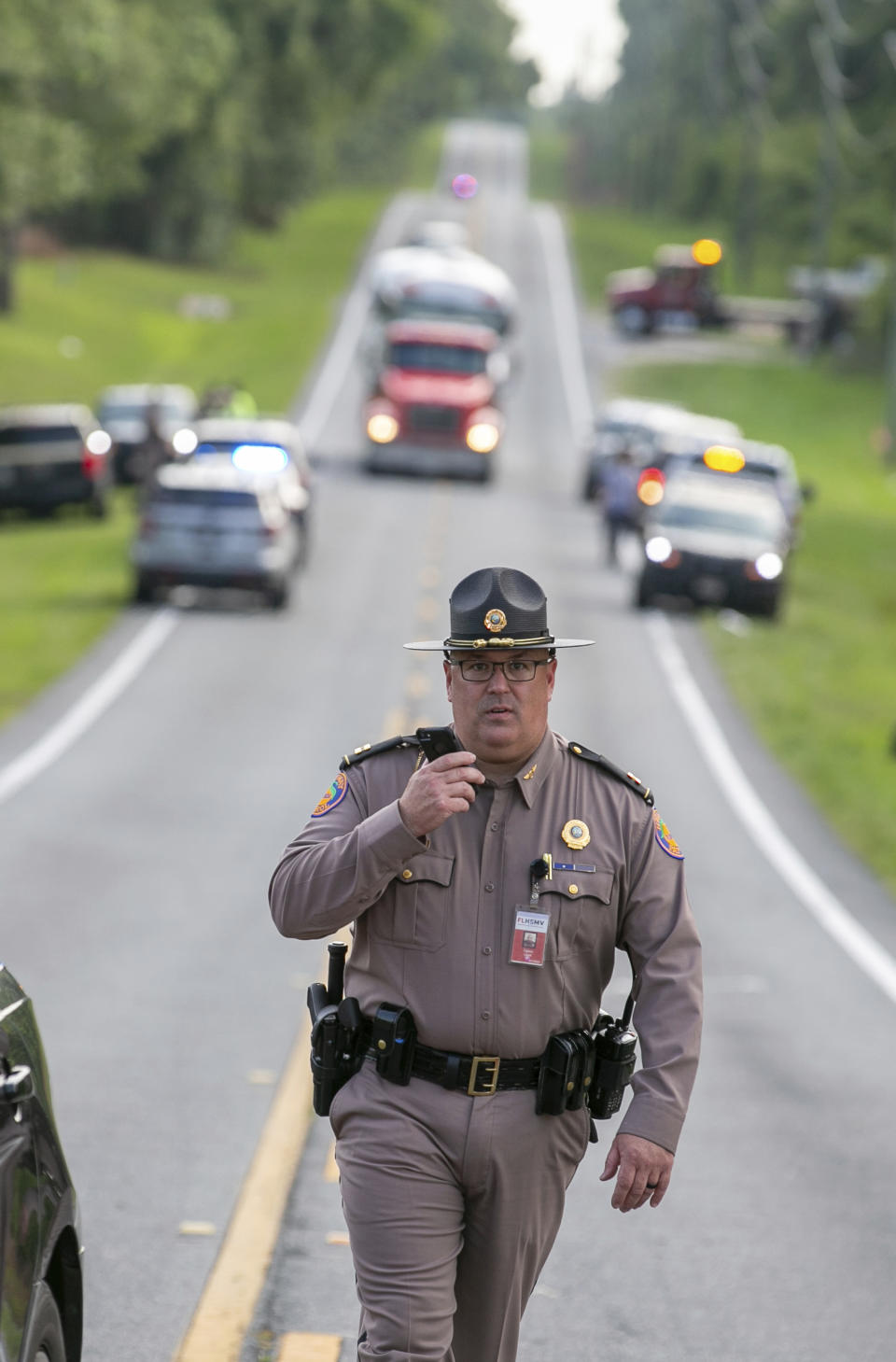 Authorities work at the scene of a deadly crash after a bus carrying farmworkers collided with a pickup truck on State Road 40 Tuesday, May 14, 2024, near Dunnellon, Fla. (AP Photo/Alan Youngblood)