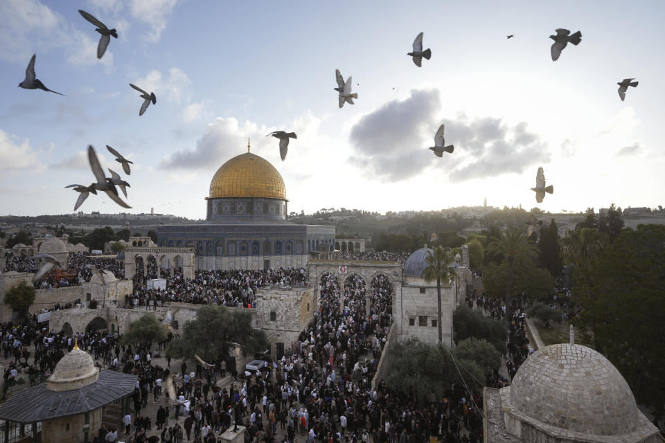 Palestinians attend Eid al-Fitr holiday celebrations by the Dome of the Rock shrine in the Al Aqsa Mosque compound in Jerusalem's Old City, Friday, April 21, 2023. The holiday marks the end of the holy month of Ramadan, when devout Muslims fast from sunrise to sunset. (AP Photo/Mahmoud Illean)