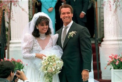 Arnold Schwarzenegger poses with his bride, Maria Kennedy Shriver, after their wedding on April 25, 1986. (AP file photo)