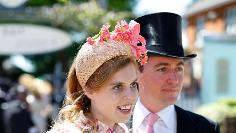 Princess Beatrice wearing a floral headband and dress with husband