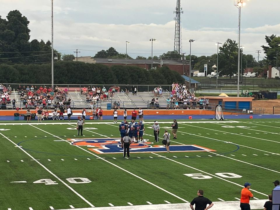 Captains meet at midfield before Lexington Senior took on Central Davidson on Friday, Aug. 19, 2022. It was the first football game played on the new artificial turf at Philpott Memorial Stadium.