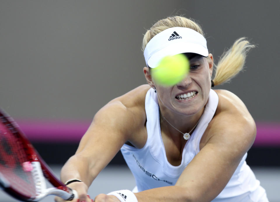 Angelique Kerber of Germany plays a shot in her match against Samantha Stosur of Australia during the Fed Cup semifinals between Australia and Germany in Brisbane, Australia, Sunday, April 20, 2014. (AP Photo/Tertius Pickard)