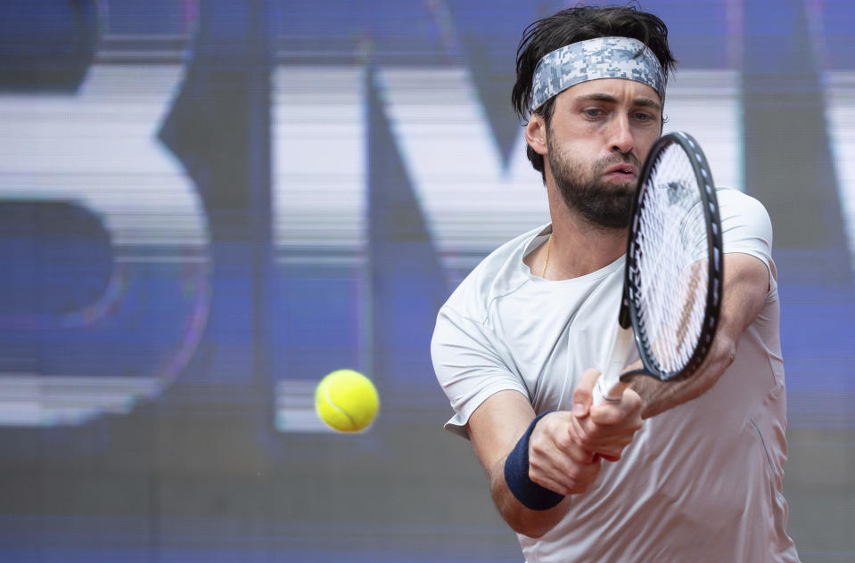 Nikoloz Basilashvili of Georgia returns the ball to Jan-Lennard Struff of Germany during his tennis ATP final match in Munich, Germany, Sunday, May 2, 2021. (Sven Hoppe/dpa via AP)