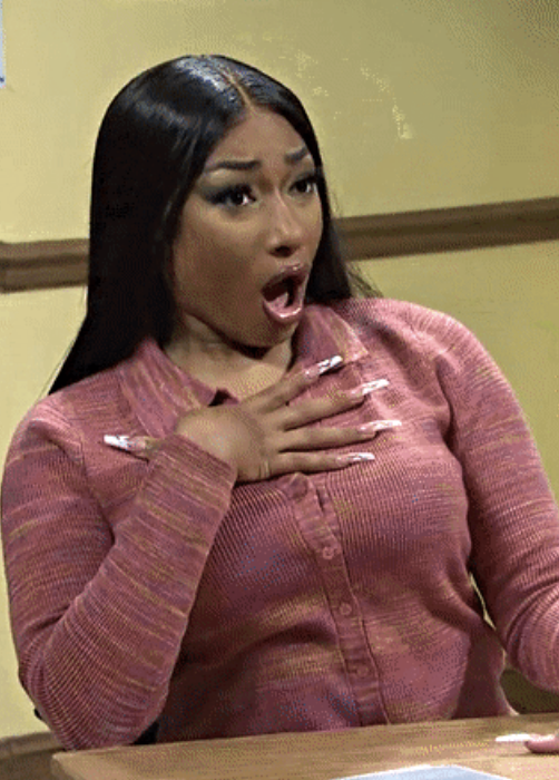 Megan Thee Stallion on "SNL" with her hand on her chest and mouth open in shock