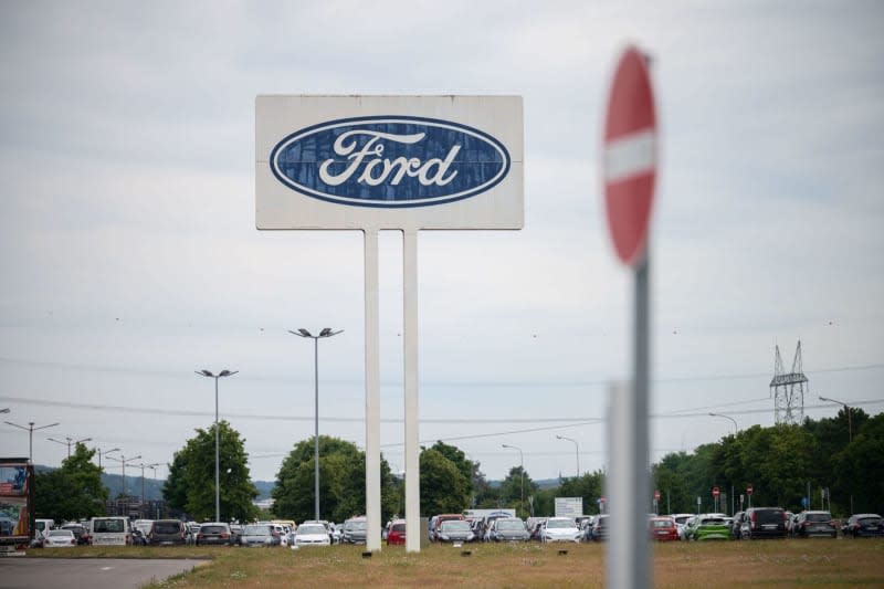 The large Ford logo is seen in the parking lot of the Saarlouis plant, with a "No through traffic" sign in front of it. Oliver Dietze/dpa