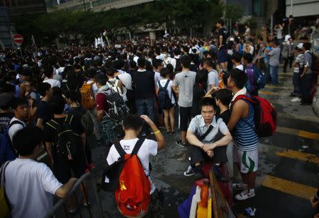 A man take a rest as protesters gather around the Golden Baihinia Square during an official flag raising ceremony to commemorate the Chinese National Day in Hong Kong, October 1, 2014. REUTERS/Carlos Barria