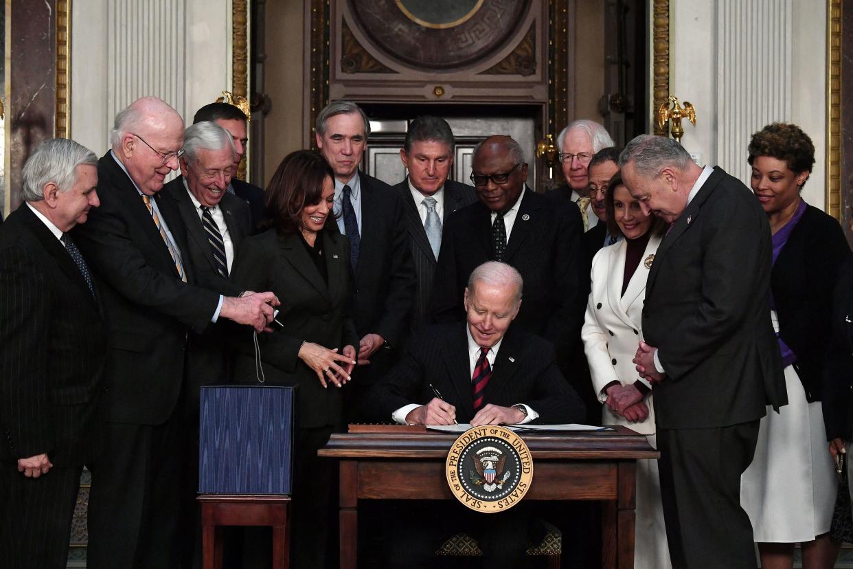 U.S. President Joe Biden is joined by Vice President Kamala Harris, Office of Management and Budget acting Director Shalanda Young and Congressional leaders as he signs the "Consolidated Appropriations Act" in the Indian Treaty Room in the Eisenhower Executive Office Building on March 15, 2022, in Washington, DC.