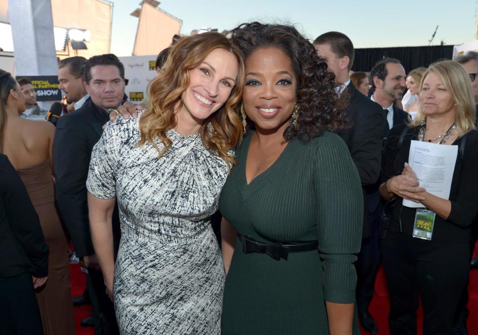 Julia Roberts, left, and Oprah Winfrey arrive at the 19th annual Critics' Choice Movie Awards at the Barker Hangar on Thursday, Jan. 16, 2014, in Santa Monica, Calif. (Photo by John Shearer/Invision/AP)