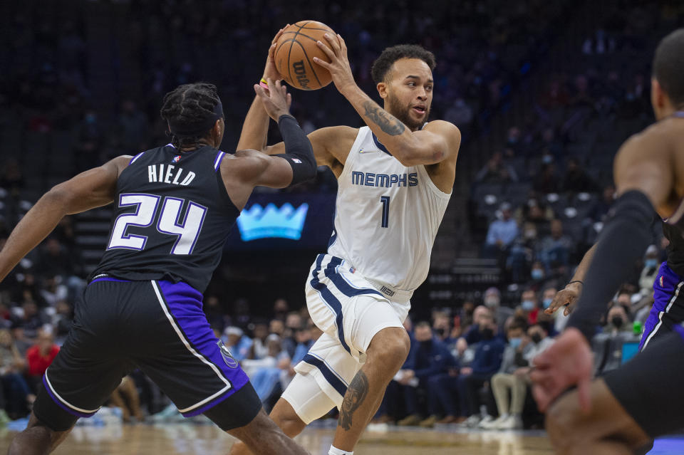 Memphis Grizzlies forward Kyle Anderson (1) drives past Sacramento Kings guard Buddy Hield (24) during the first quarter of an NBA basketball game in Sacramento, Calif., Friday, Dec. 17, 2021. (AP Photo/Randall Benton)