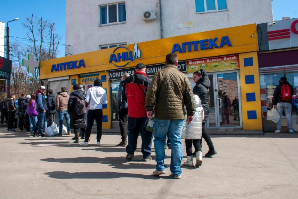 People line up at a pharmacy in Kharkiv on Wednesday (AP)