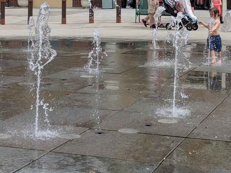 water coming up from the ground in the splash pad area at disney springs