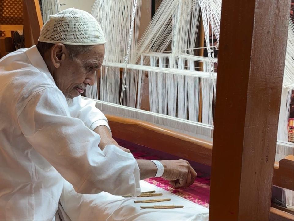 An artisan creating a piece of handmade silk in Mumbai, India.