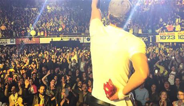 Enrique Iglesias hides his bloody hand after grabbing a drone