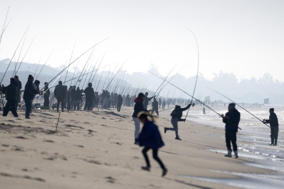 Fishermen compete in the Brotola Fishing Contest at Las Toscas beach, Uruguay, Sunday, July 3, 2022. More than 500 fishermen competed in the contest. (AP Photo/Matilde Campodonico)