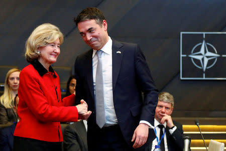 U.S. Ambassador to NATO Kay Bailey Hutchison shakes hands with Macedonian Foreign Minister Nikola Dimitrov during a signature ceremony of the accession protocol between the Republic of North Macedonia and NATO at the Alliance headquarters in Brussels, Belgium February 6, 2019. REUTERS/Francois Lenoir/Pool