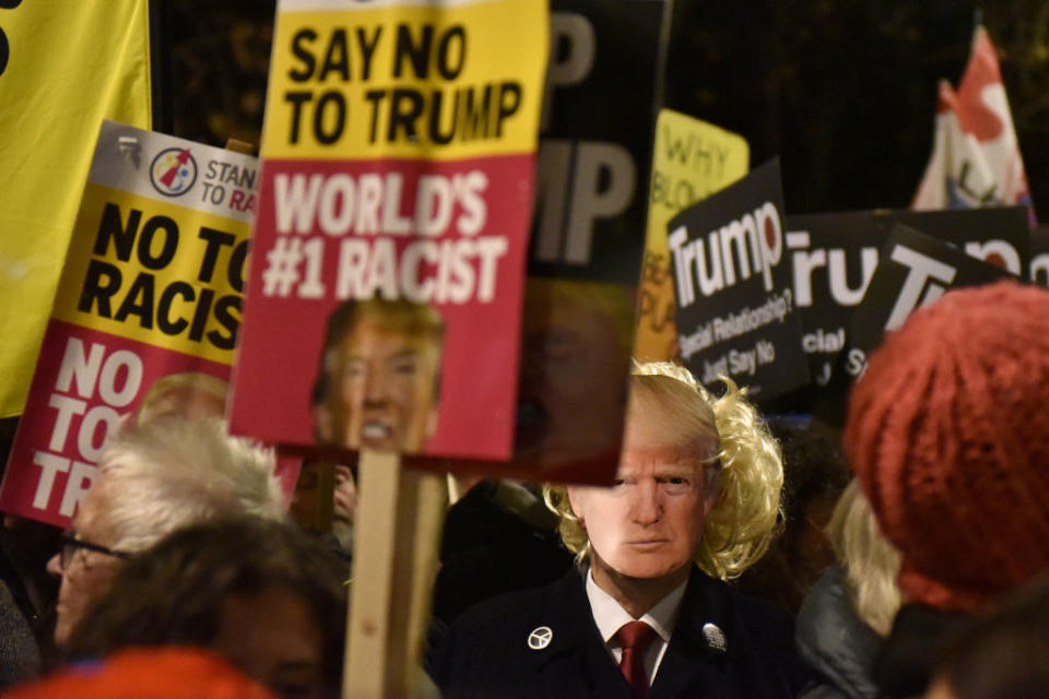 Anti Trump protesters hold "Say No To Trump and World's #1 Racist" placards as NATO leaders attend Buckingham Palace on December 3. Source: John Keeble/Getty Images