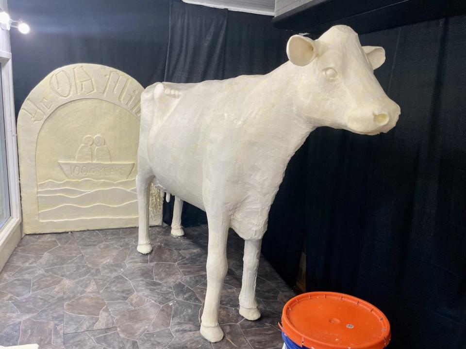 The 2022 butter cow sits in its cooler in the John Deere Agriculture Building at the Iowa State Fair.