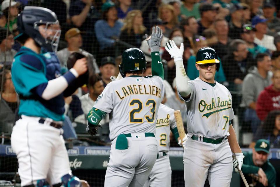 SEATTLE, WASHINGTON - SEPTEMBER 30: Shea Langeliers #23 of the Oakland Athletics reacts with Jonah Bride #77 after his home run during the second inning against the Seattle Mariners at T-Mobile Park on September 30, 2022 in Seattle, Washington. (Photo by Steph Chambers/Getty Images)