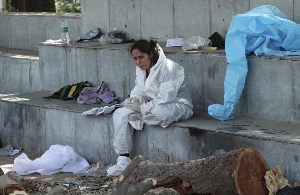 A relative of a person who died of COVID-19 mourns at a crematorium in Jammu, in Jammu, India, Friday, April 30, 2021. Indian scientists appealed to Prime Minister Narendra Modi to publicly release virus data that would allow them to save lives as coronavirus cases climbed again Friday, prompting the army to open its hospitals in a desperate bid to control a massive humanitarian crisis. (AP Photo/Channi Anand)