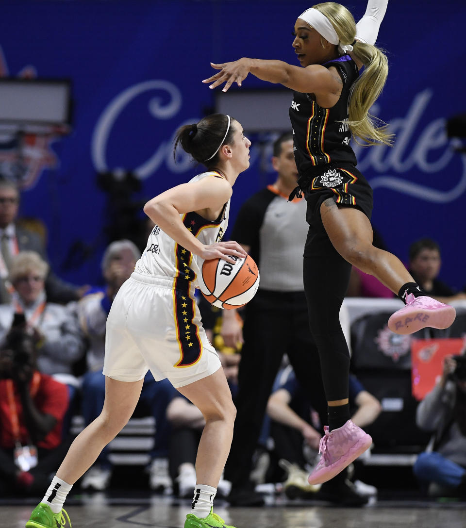 Connecticut Sun guard DiJonai Carrington (21) defends against Indiana Fever guard Caitlin Clark (22) during the first quarter of a WNBA basketball game, Tuesday, May 14, 2024, in Uncasville, Conn. (AP Photo/Jessica Hill)