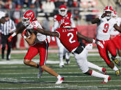 Maryland running back Peny Boone (13) runs after a catch A Rutgers defensive back Avery Young (2) tries to tackle him during the first half of an NCAA football game, Saturday, Nov. 27, 2021, in Piscataway, N.J. (AP Photo/Noah K. Murray)