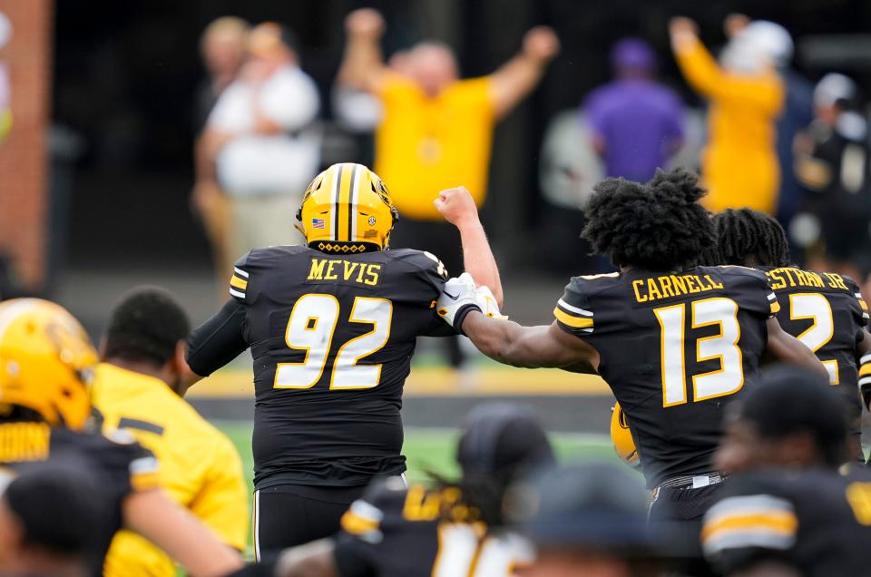 Missouri Tigers place kicker Harrison Mevis (92) celebrates with teammates after kicking the game winning field goal as time expires in the second half against the Kansas State Wildcats at Faurot Field at Memorial Stadium.