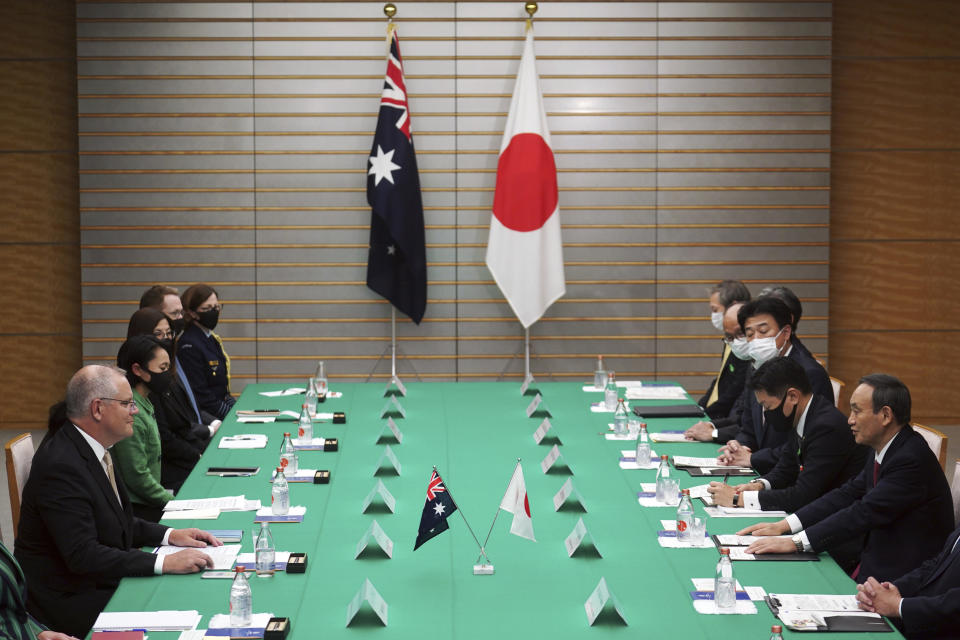 Australian Prime Minister Scott Morrison, left, and his Japanese counterpart Yoshihide Suga, right, attend a bilateral meeting at Suga's official residence in Tokyo Tuesday, Nov. 17, 2020. Morrison is in Japan to hold talks with his Japanese counterpart, Yoshihide Suga, to bolster defense ties between the two U.S. allies to counter China’s growing assertiveness in the Asia-Pacific region. (AP Photo/Eugene Hoshiko, Pool)