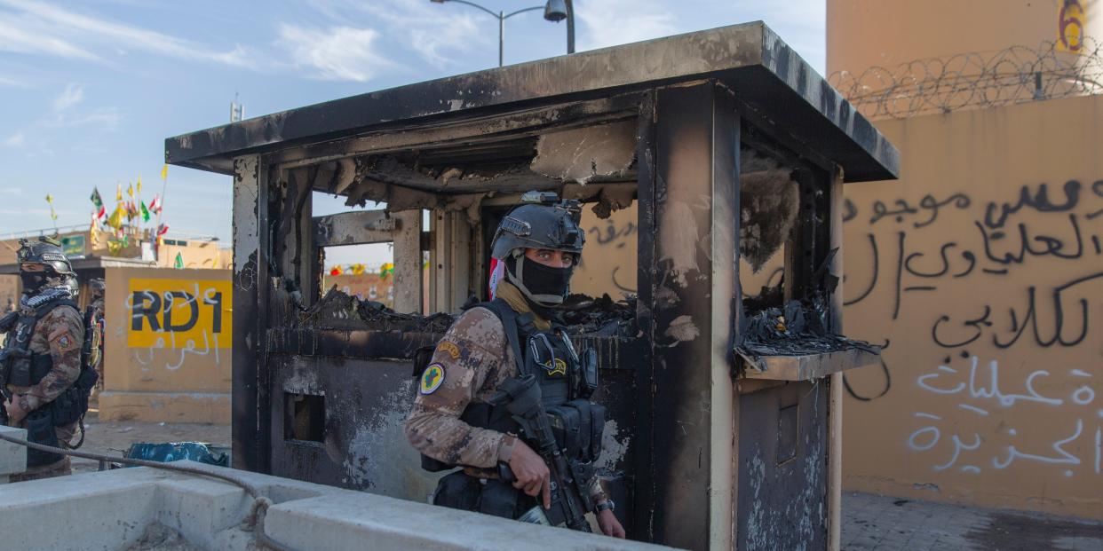 Iraqi army soldiers are deployed in front of the U.S. embassy, in Baghdad, Iraq, Wednesday, Jan. 1, 2020.