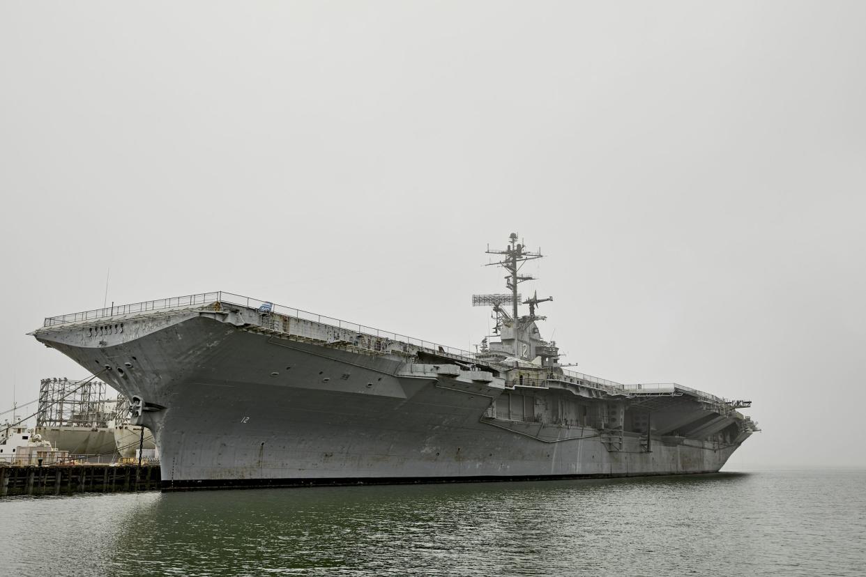 Alameda, California, USA - December 19, 2018: Vintage WWII era aircraft carrier Hornet military ship in port at dock.