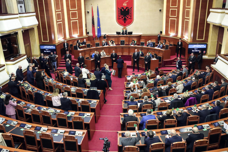 Lawmakers of the Democratic Party, left, look on as their colleagues of the ruling Socialist party vote in Tirana, Albania, Thursday, Feb. 22, 2024. Albania’s Parliament on Thursday approved a deal for the country to hold thousands of migrants rescued in international waters by Italy while their asylum applications are processed, despite protests from opposition lawmakers and human rights groups. (AP Photo/Armando Babani)