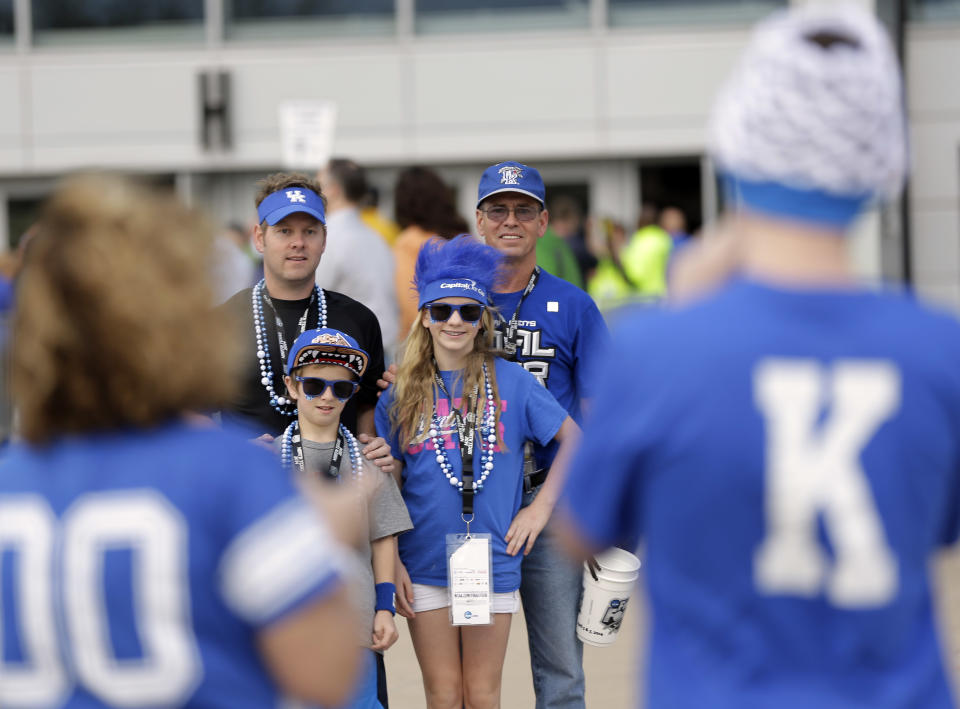 Kentucky fans pause to take picture outside AT&T Stadium before the NCAA Final Four tournament college basketball championship game against Connecticut Monday, April 7, 2014, in Arlington, Texas. (AP Photo/Eric Gay)