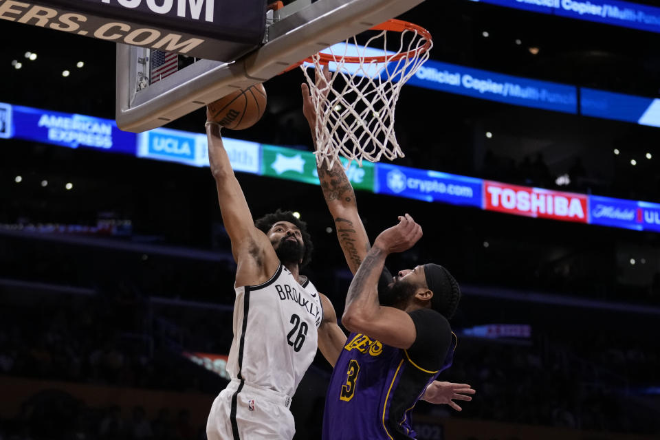 Brooklyn Nets guard Spencer Dinwiddie (26) shoots against Los Angeles Lakers forward Anthony Davis (3) during the first half of an NBA basketball game in Los Angeles, Friday, Jan. 19, 2024. (AP Photo/Ashley Landis)