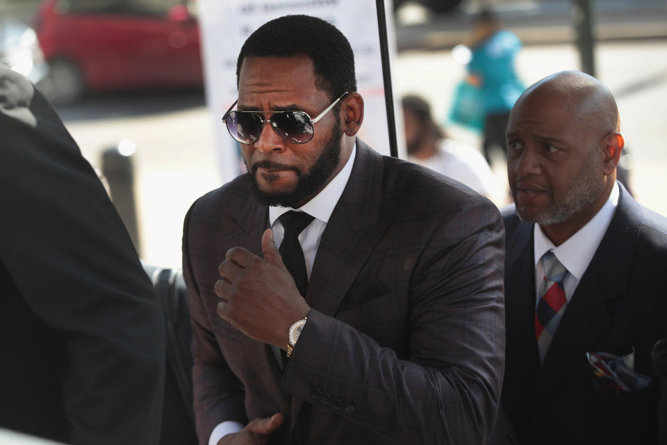 R&B singer R. Kelly (C) arrives at the Leighton Criminal Courts Building for a hearing on June 26, 2019 in Chicago, Illinois. Kelly is facing several counts of aggravated sexual abuse.