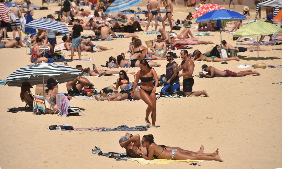 Beachgoers soak up the sun on Bondi beach.