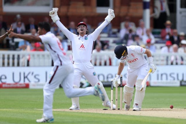 Gudakesh Motie (left) bowls Joe Root