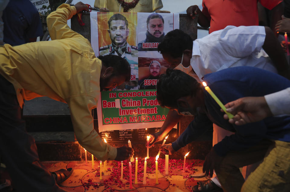 Indians light candles in Hyderabad, India, to pay tributes to Indian soldiers killed during confrontation with Chinese soldiers,, Wednesday, June 17, 2020. Indian security forces said neither side fired any shots in the clash in the Ladakh region late Monday that was the first deadly confrontation on the disputed border between India and China since 1975. China said Wednesday that it is seeking a peaceful resolution to its Himalayan border dispute with India following the death of 20 Indian soldiers in the most violent confrontation in decades.(AP Photo/Mahesh Kumar A.)