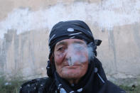 <p>A woman smokes as she rests after she was evacuated with others by the Syria Democratic Forces (SDF) fighters from an Islamic State-controlled neighbourhood of Manbij, in Aleppo Governorate, Syria, Aug. 12, 2016. (REUTERS/Rodi Said) </p>