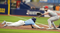 Tampa Bay Rays' Richie Palacios (1) dives back safely ahead of the pickoff throw to Los Angeles Angels first baseman Nolan Schanuel during the first inning of a baseball game Thursday, April 18, 2024, in St. Petersburg, Fla. (AP Photo/Chris O'Meara)