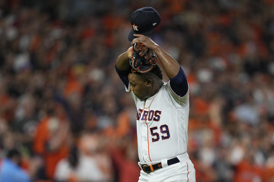 Houston Astros starting pitcher Framber Valdez wipes his face after giving up two run during the first inning of Game 1 in baseball's World Series between the Houston Astros and the Atlanta Braves Tuesday, Oct. 26, 2021, in Houston. (AP Photo/David J. Phillip)