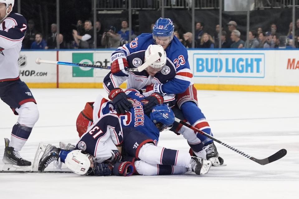 New York Rangers' Adam Fox (23) grabs Columbus Blue Jackets' Mathieu Olivier (24) during a fight in the second period of an NHL hockey game Wednesday, Feb. 28, 2024, in New York. (AP Photo/Frank Franklin II)