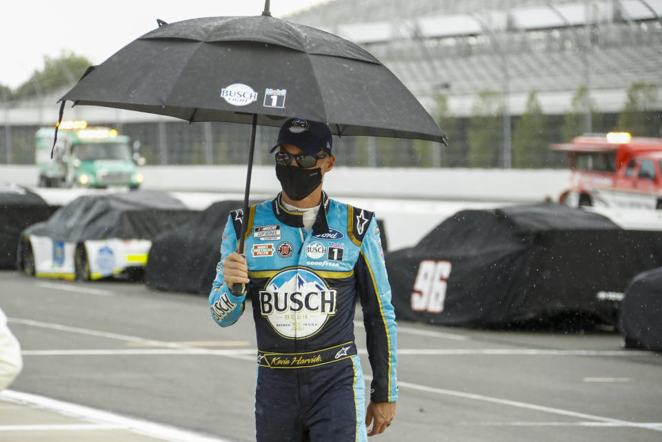 Kevin Harvick walks down pit road during a weather delay during the NASCAR Cup Series auto race at Pocono Raceway, Sunday, June 28, 2020, in Long Pond, Pa. (AP Photo/Matt Slocum)