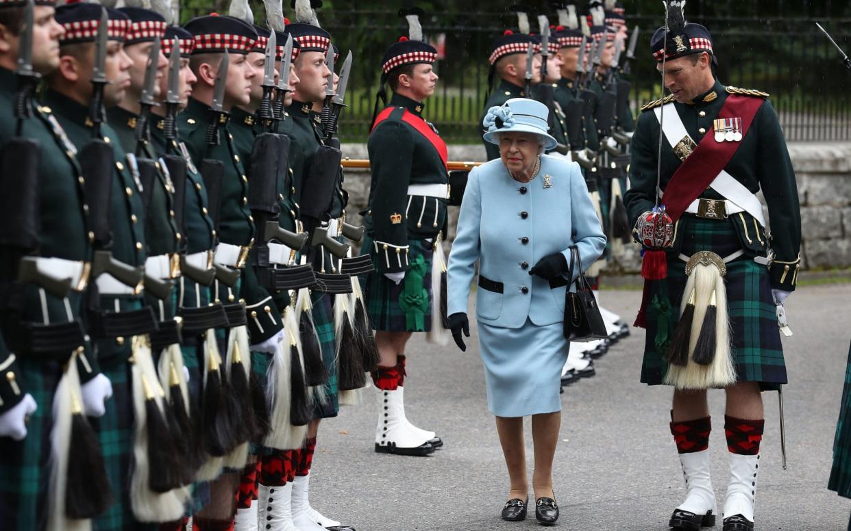 The Queen inspects a Royal Regiment at the gates of Balmoral ahead of taking up summer residence at the castle. - PA