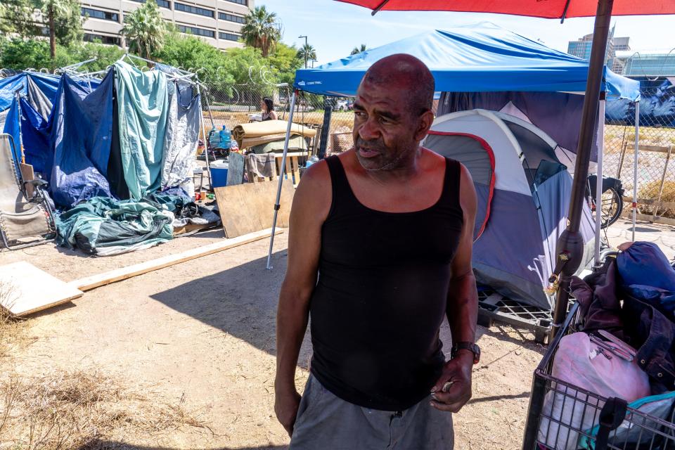 Antoin "Applejacks" Jackson, 59, stands near his tent at a homeless encampment known as "The Zone" along 9th Avenue near Jefferson Street in Phoenix on April 28, 2023.