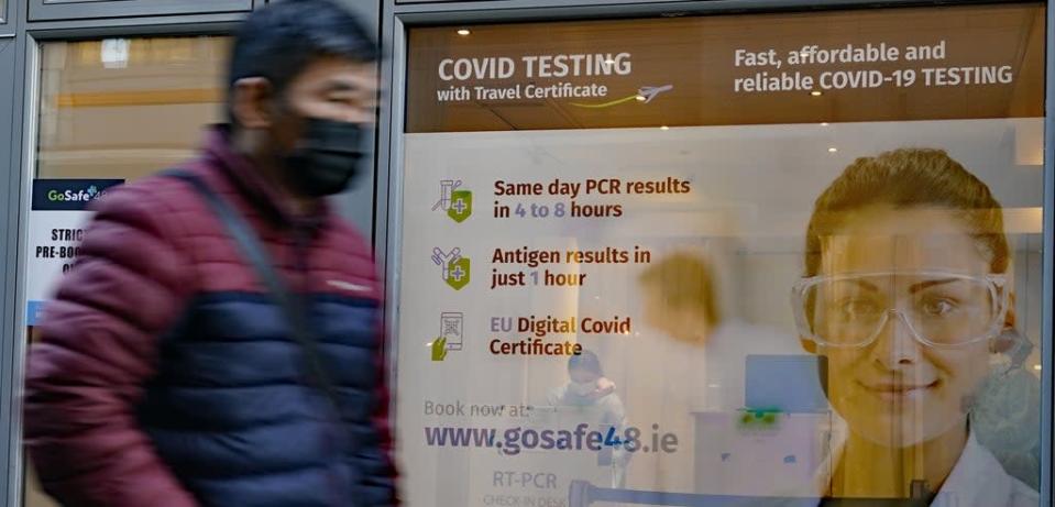 People pass a Covid-19 testing centre in Dublin city centre as the Government is to consider plans to relax the rules around close contacts, following public health advice (PA) (PA Wire)