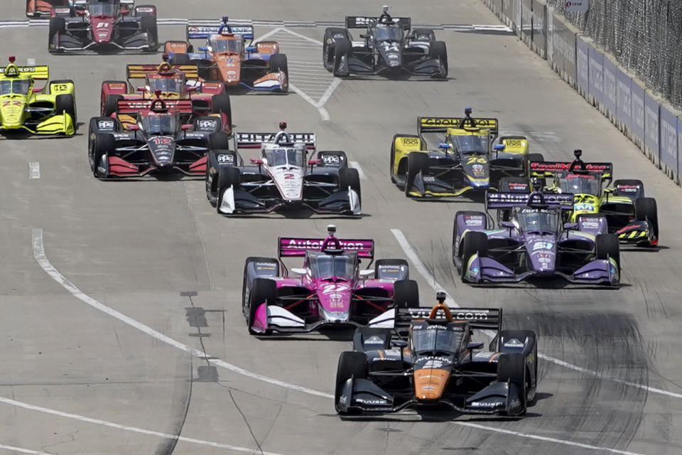 Pole sitter Pato O'Ward leads the field during the first race of the IndyCar Detroit Grand Prix auto racing doubleheader on Belle Isle in Detroit Saturday, June 12, 2021. (AP Photo/Paul Sancya)