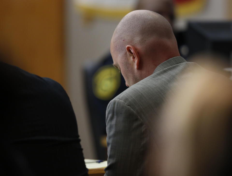 Fired Balch Springs police officer Roy Oliver, who was convicted for the murder of 15-year-old Jordan Edwards, lowers his head while his mother gives testimony during the sentencing phase at the Frank Crowley Courts Building in Dallas on Wednesday, Aug. 29, 2018. Oliver is a good man and a devoted father, his mother testified Wednesday as she urged jurors to impose a lenient prison sentence. (Rose Baca/The Dallas Morning News via AP, Pool)