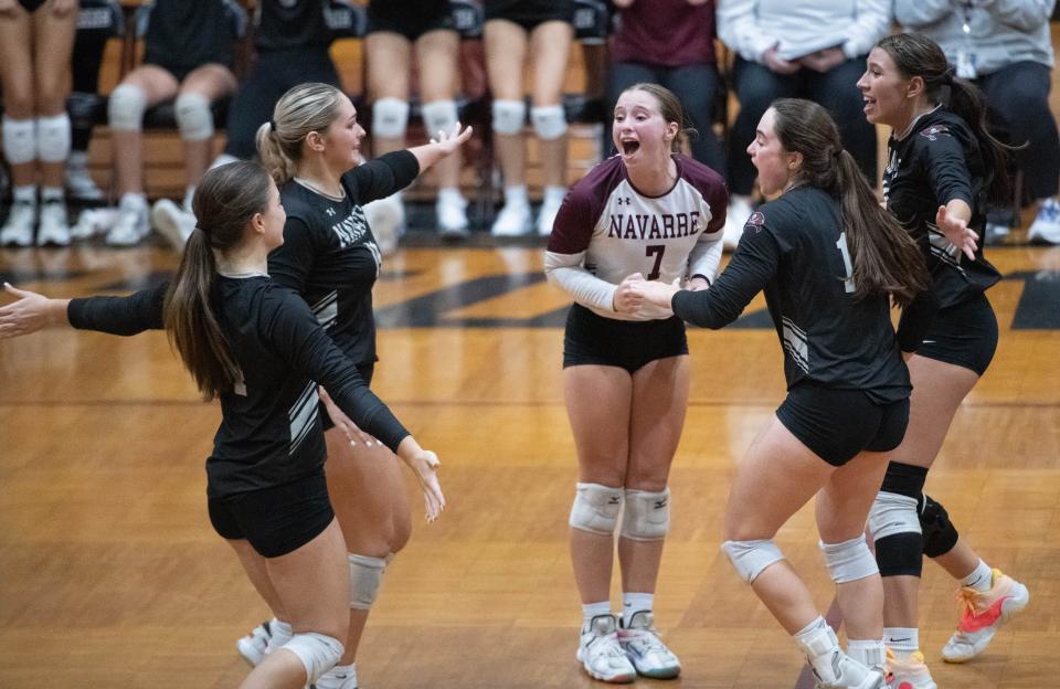 The Raiders celebrate taking a commanding lead in the fifth set during the Pace vs Navarre 1-6A District volleyball tournament at Navarre High School on Tuesday, Oct. 17, 2023.