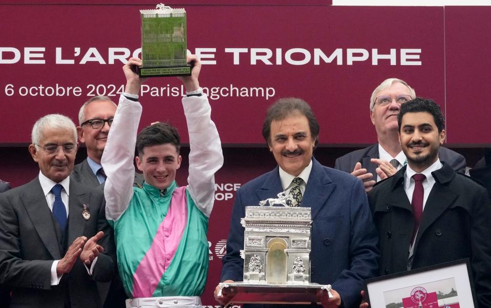 Jockey Rossa Ryan and the representatives of Juddmonte, owners of Bluestocking, pose with their trophies after victory in the Prix de l'Arc de Triomphe